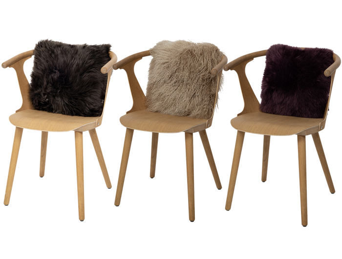 three sheepskin cushions on chairs