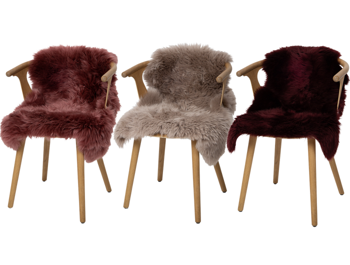 three sheepskin rugs on chairs