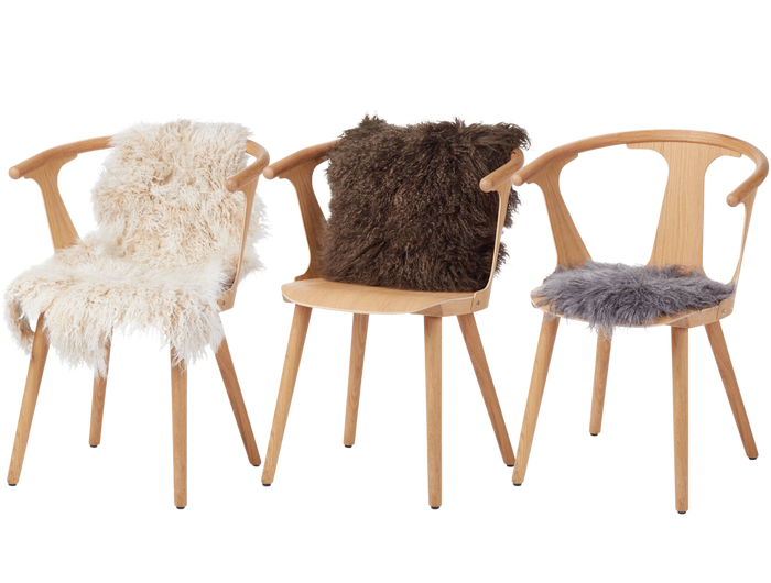 three tibetan sheepskin products on chairs